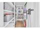 Organized storage closet with built-in shelving and neatly arranged gray storage bins at 2202 E Lincoln Dr, Phoenix, AZ 85016