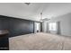 Spacious bedroom features high ceilings, a ceiling fan, and abundant natural light at 23420 N 121St Ave, Sun City, AZ 85373