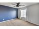 Cozy bedroom with a ceiling fan, neutral carpet, and a window at 23420 N 121St Ave, Sun City, AZ 85373