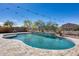 Backyard pool area enhanced with string lights, landscaping, and a serene outdoor space at 23420 N 121St Ave, Sun City, AZ 85373