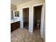 Bathroom with vanity and sink, toilet, and a door to the walk-in closet at 25766 W Valley View Dr, Buckeye, AZ 85326