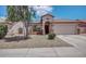 Charming single-Gathering home featuring a two-car garage, red tile roof, and desert landscaping at 25766 W Valley View Dr, Buckeye, AZ 85326