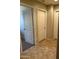 Hallway featuring tile floors, neutral walls, and white doors at 25766 W Valley View Dr, Buckeye, AZ 85326
