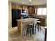 Well-lit kitchen featuring granite counters, tile floors, island with seating, and stainless steel appliances at 25766 W Valley View Dr, Buckeye, AZ 85326