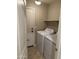 Laundry room with full size washer and dryer and storage shelf at 25766 W Valley View Dr, Buckeye, AZ 85326