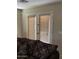 Living room view of patio doors featuring window blinds and a floral sofa set at 25766 W Valley View Dr, Buckeye, AZ 85326