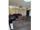Open living room features tile floors, ceiling fan, couch, chairs and an entertainment center at 25766 W Valley View Dr, Buckeye, AZ 85326