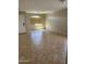 Well-lit, empty living room with neutral walls and tile floors creating a move-in-ready space at 25766 W Valley View Dr, Buckeye, AZ 85326