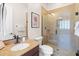 Bathroom featuring a stone vanity, toilet, and a glass door shower with matching stone at 27020 N 14Th Ln, Phoenix, AZ 85085