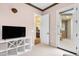 Bright bedroom featuring neutral tones, with a door to the bathroom and another to the entryway at 27020 N 14Th Ln, Phoenix, AZ 85085