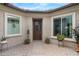 Charming front patio with potted plants, decorative accents, and a secure front entrance at 27020 N 14Th Ln, Phoenix, AZ 85085