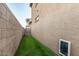 Narrow backyard featuring low-maintenance artificial turf and a block wall for privacy at 291 N Scott Dr, Chandler, AZ 85225