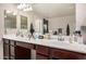Bathroom featuring a double sink vanity with white countertops and dark wood cabinets at 291 N Scott Dr, Chandler, AZ 85225