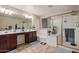 Bathroom with a double sink vanity, large mirror, bathtub, and separate glass shower at 291 N Scott Dr, Chandler, AZ 85225