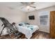 Cozy bedroom with wood-look floors, ceiling fan, and inversion table at 291 N Scott Dr, Chandler, AZ 85225