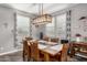 Dining room featuring a large wooden table with upholstered chairs and modern lighting fixture at 291 N Scott Dr, Chandler, AZ 85225