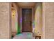 View of door and entryway to tan home. Bench with candles on the right at 291 N Scott Dr, Chandler, AZ 85225