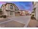 View of several homes with front garages in community with colorful sunset in background at 291 N Scott Dr, Chandler, AZ 85225