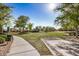 Well-maintained community green space with walking path, mature trees, and landscaping for neighborhood enjoyment at 291 N Scott Dr, Chandler, AZ 85225