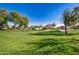 Large community green space with mature trees, manicured lawn, and walking paths for residents to enjoy at 291 N Scott Dr, Chandler, AZ 85225