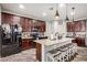 Kitchen with dark cabinets, granite countertops, stainless appliances, and an island with seating at 291 N Scott Dr, Chandler, AZ 85225