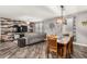 Open living and dining area with wood-look floors, accent wall, and modern decor and lots of natural light at 291 N Scott Dr, Chandler, AZ 85225
