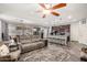 Open-concept living room and kitchen area with modern furnishings, kitchen island, and wood-look flooring at 291 N Scott Dr, Chandler, AZ 85225