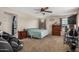 Bright main bedroom with carpet flooring, ceiling fan, and a dresser at 291 N Scott Dr, Chandler, AZ 85225