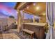 Relaxing covered patio featuring a hot tub, BBQ grill and privacy curtains for evening relaxation at 291 N Scott Dr, Chandler, AZ 85225