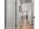 Bright hallway with wood floors, white doors, and a view into the living area at 3192 N Park St, Buckeye, AZ 85396