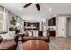 Stylish living area with leather sofa, round coffee table, and view of a modern kitchen with dark cabinets at 3192 N Park St, Buckeye, AZ 85396