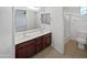 Bright bathroom with double sink vanity, shower, and neutral tile flooring at 3316 W Hayduk Rd, Laveen, AZ 85339