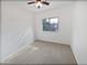 Bedroom featuring a ceiling fan, neutral carpet, and a view to the home's exterior at 3316 W Hayduk Rd, Laveen, AZ 85339