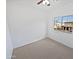 Bright bedroom featuring neutral carpet, a ceiling fan, and a window providing natural light at 3316 W Hayduk Rd, Laveen, AZ 85339