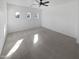 Spacious bedroom with neutral carpet, ceiling fan, and multiple arched windows providing ample natural light at 3316 W Hayduk Rd, Laveen, AZ 85339