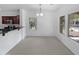 Bright dining area featuring neutral carpet, natural light from windows, and access to the kitchen with stainless steel appliances at 3316 W Hayduk Rd, Laveen, AZ 85339