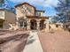 Charming two-story home featuring stucco siding, arched entryway, and low-maintenance landscaping at 3316 W Hayduk Rd, Laveen, AZ 85339