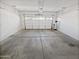Spacious two car garage featuring a garage door and concrete flooring at 3316 W Hayduk Rd, Laveen, AZ 85339