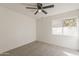 Bright bedroom with neutral carpet, a ceiling fan, and a window overlooking backyard at 3369 W Sandra Ter, Phoenix, AZ 85053