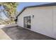 Exterior view of patio with sliding glass door, stucco wall, and natural shade at 3369 W Sandra Ter, Phoenix, AZ 85053