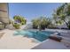 Backyard pool with diving board surrounded by mature landscaping at 3369 W Sandra Ter, Phoenix, AZ 85053