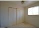 Bedroom with tile floors, large closet, and window at 3640 W Garfield St, Phoenix, AZ 85009