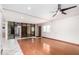 Airy living space boasting hardwood flooring, a modern ceiling fan and access to other rooms at 3822 W Flower St, Phoenix, AZ 85019