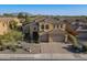 Expansive aerial shot of a Southwestern-style house showcasing its desert landscaping and two-car garage at 3859 E Wood Dr, Chandler, AZ 85249