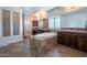 Bright bathroom with a large soaking tub, dual vanities, and a glass block window for natural light at 3859 E Wood Dr, Chandler, AZ 85249
