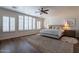 Tranquil bedroom with plantation shutters, a ceiling fan, neutral tones, and plush bedding at 3859 E Wood Dr, Chandler, AZ 85249