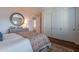 Bedroom with a round mirror over a dresser and closet with three sliding doors at 3859 E Wood Dr, Chandler, AZ 85249