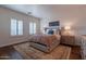 Bedroom featuring a large rug, neutral color scheme and plantation shutters on the windows at 3859 E Wood Dr, Chandler, AZ 85249