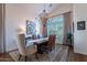 Formal dining room with a rustic table, stylish chandelier, and serene window views for elegant dinners at 3859 E Wood Dr, Chandler, AZ 85249