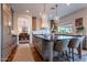 Bright kitchen features a large island with pendant lights, counter seating, and dining area in the background at 3859 E Wood Dr, Chandler, AZ 85249